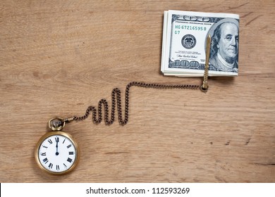 Pocket Watch And Cash Money On Wood