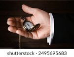 pocket watch in the hands of a man