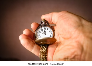 pocket watch in the hands of a man - Shutterstock ID 1636080934