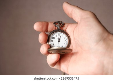 pocket watch in the hands of a man - Shutterstock ID 2269531475