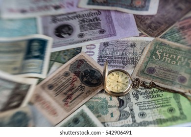 A Pocket Watch On Old Bank Notes