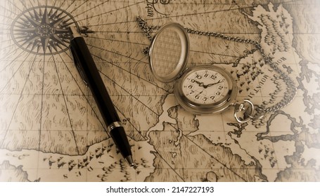 Pocket watch on old world map. Map picture is downloaded from free resource. Link: unsplash.com. Legal: unsplash.com license