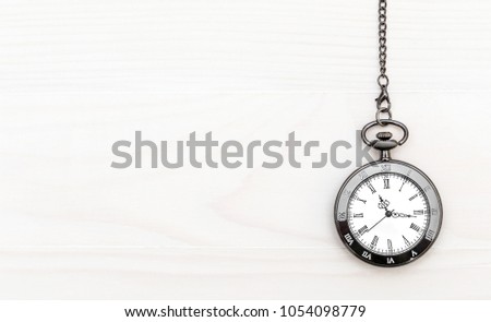 Pocket watch on wooden background. Copy space for text.