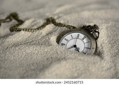 A Pocket Watch In Sand - Powered by Shutterstock