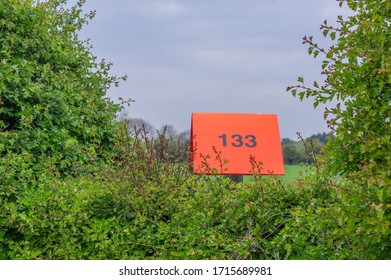 Pocklington, East Yorkshire, UK, 04/26/2020 - A Bright Orange Marker Post For A Buried Pipeline.