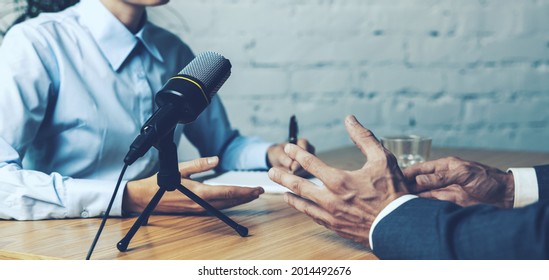 podcast interview recording - radio host discussion with businessman in broadcasting studio. banner copy space - Powered by Shutterstock