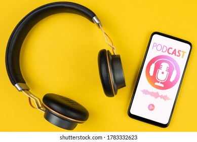 Podcasting Concept, Above View Of Headphones And Smartphone With Podcast Player Mockup On Yellow Background