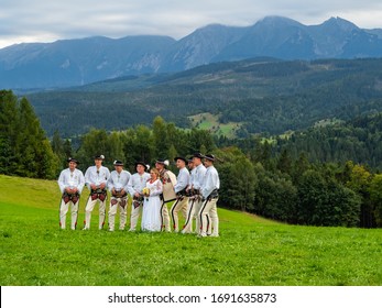 Podhale/Poland - 14/09/2019 High Tatra mountains in Poland. View from Lapszanka near Zakopane. People in traditional outfit having wedding photoshoot in amazing place.