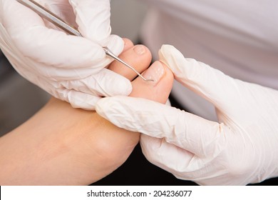 podiatrist ( chiropodist ) cleaning woman feet