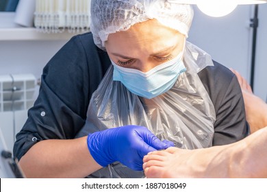 The podiatrist does a pedicure in the salon. Pedicure procedure with nail clipper tool. - Shutterstock ID 1887018049