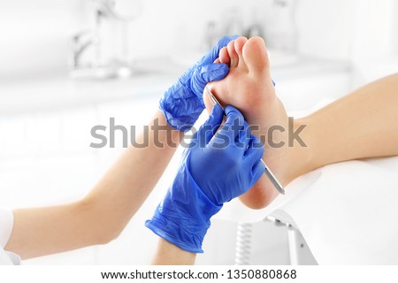 Podiatry. Removing calluses with a scalpel at the beautician. Zdjęcia stock © 