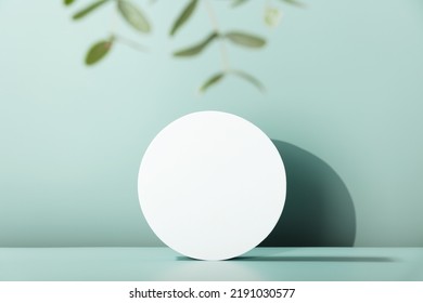 Podium for cosmetic product presentation. Abstract minimal geometrical form. Cylinder podium with eucalyptus leaves, geometric shadows. Scene to show products. Showcase, display case. - Shutterstock ID 2191030577