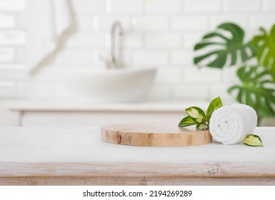 Podium for product display and towel on blurred bathroom background