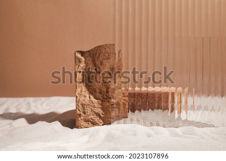 Podium stand and textured glass on sand background. Display for cosmetic perfume fashion natural product