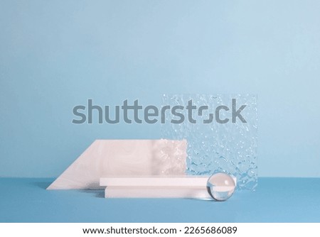 Podiums made of stone and glass, blue background. Abstract product showcase