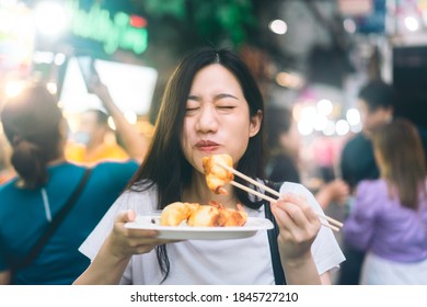 Poeple Travel And Eating Street Food Concept. Happy Young Adult Asian Foodie Woman Holding Gyoza At Chinatown Yaowarat Market, Bangkok, Thailand.