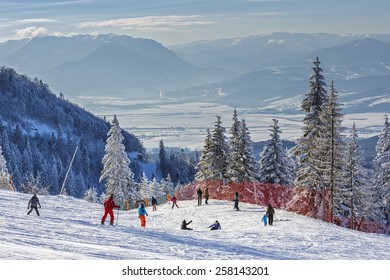 POIANA BRASOV, ROMANIA - FEBRUARY 11, 2015: Unknown group of skiers descend the ski slopes in Poiana Brasov, the most famous Romanian winter resort, in Postavaru Mountain, Brasov county.