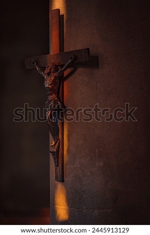 
A poignant depiction of Jesus on the crucifix, illuminated by the colorful interplay of light filtering through the church's stained glass windows.