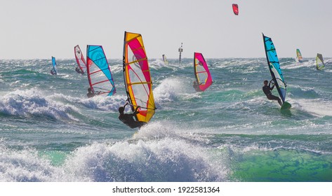 Point de Carro, France - February 21, 2021: windsurfers enjoy windy winter day at Mediterranean Sea 
