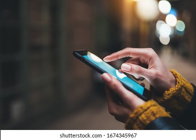 point finger on screen mobile phone closeup, person texting text message, hipster touch blue screen on smartphone light night city, girls using in hands cellphone close up, online internet - Shutterstock ID 1674345967