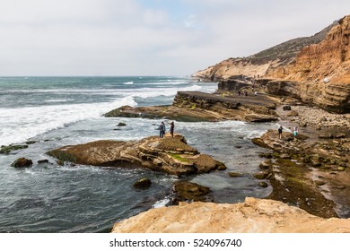POINT LOMA, CALIFORNIA - APRIL 4, 2016: People explore the tide pool area on a cloudy day in part of the Cabrillo National Monument in San Diego, California.