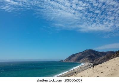 Point Mugu and Thornhill Broome Beach seen from Sandy Dune under beautiful sunny cloudscape in Malibu Southern California - Shutterstock ID 2085806359