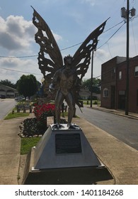 Point Pleasant, West Virginia / USA - 05/18/2019: Mothman Statue Standing Outside Of The Mothman Museum At A Street Intersection.