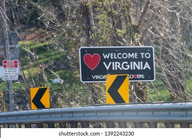 Point of Rocks, USA - April 6, 2018: Red heart sign on highway in Virginia with welcome to state sign and lovers text logo icon
