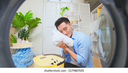 Point Of View Asian Man Doing Laundry And Is Satisfied With The Clothing Smell