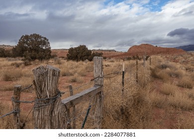 Point of view from barbwire cattle fence as leading lines into red rock high desert in rural New Mexico - Powered by Shutterstock