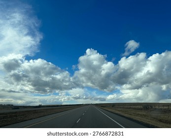Driver’s point of view driving down open road showing forward perspective, travel movement and transportation concept