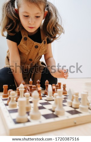 Similar – Image, Stock Photo lifestyle shot of smart kid girl playing checkers at home