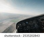 Point of view: piloting small aircraft. Cockpit of light utility aircraft - instrument panel with numerous gauges. 