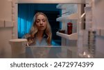 Point of view POV inside refrigerator Caucasian girl hungry woman open fridge at home kitchen look at empty shelves order food products delivery with mobile phone app online service web store shopping