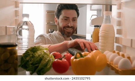 Point of view POV inside refrigerator hungry Caucasian man guy male chef open fridge with healthy vegetables choosing searching take eat apple eating fruit at home kitchen food delivery health diet - Powered by Shutterstock