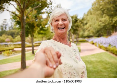 Point Of View Shot Of Senior Couple Walking In Park Together - Powered by Shutterstock