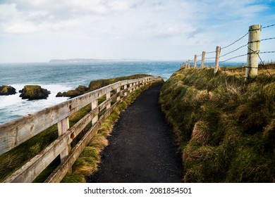 Point of view of a stunning trekking path in Giant's Causeway, Northern Ireland. An ideal destination for hiking and exploring a geological wonder. A UNESCO World Heritage Site