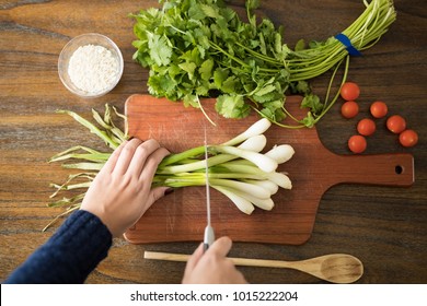 Point of view of woman cutting fresh vegetables on chopping board in kitchen - Powered by Shutterstock