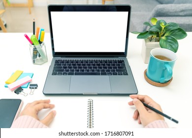 Point Of View Of Young Asian Girl Sit On Desk And Learn At Home Living Room In Concept Of Romote Learning, Virtual Online, Self Isolated Quarantine Lifestyle In Asia. White Blank Screen.