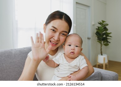 Point Of View, Young Asian Mother And Her Newborn Baby Smiling And Say Hello, Goodbye Via Video Call Or FaceTime Feeling Happy