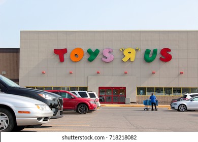 POINTE CLIARE, CANADA-SEPTEMBER 19, 2017:Employee Pushing Carts At Toys R Us Located In Quebec.  The Big Box Children's Retailer Files For Bankruptcy Protection In Canada And The United States