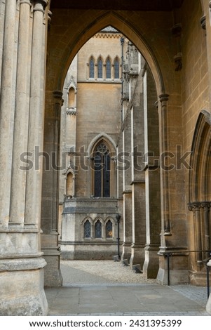 Pointed arches over the main entrance of Arundel Cathedral frame the view of Gothic windows. Famous tourist attraction and remarkable architectural masterpiece of historic and religious importance.