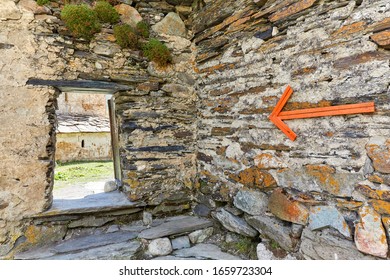 the the pointer on the stone wall on the right side