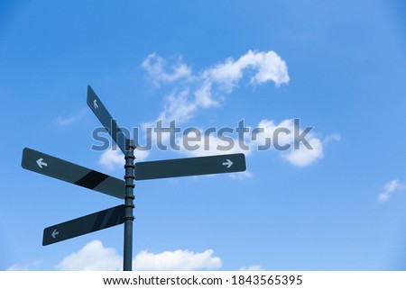 pointers on the post with arrows in different directions against the sky. signs of the way on the background of sky