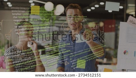 Pointing coder and trainee holding marker reviewing code on glassboard at work, stickies, pie-chart. Collaboration, whiteboard, brainstorming, diagrams, notes, charts, openplan