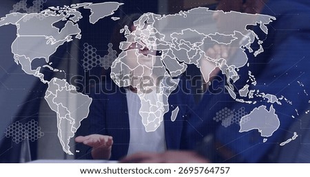 Pointing colleagues viewing world map on touchscreen in meeting room, with hex nodes. Technology, innovation, collaboration, data visualization, corporate, urban, modern