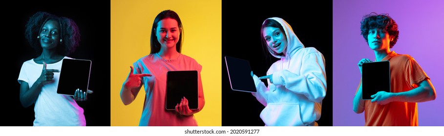 Pointing At Device Screen. Collage Of Images Of Four Young People, Smiling Man And Women With Tablets Isolated Over Multicolored Neon Backgrounds. Copyspace For Ad.