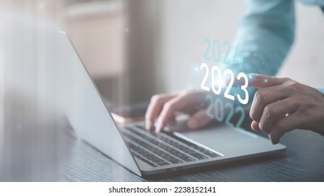 Pointing with a finger on a virtual interface in the year 2023,
Plans to accelerate corporate expansion and growth until 2023,
Beginning 2023 New Year's business planning