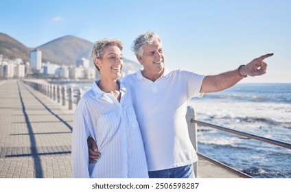 Pointing, happy and mature couple in beach, hug and bonding in vacation for fresh air, smile or nature. Holiday, old man and woman for romance in Australia, travel and date in ocean, enjoy or weekend - Powered by Shutterstock