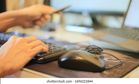 Pointing Laptop Monitor With Digital Pen. Working Seriously With Concentration. Hand Typing On Keyboard Number Pad While Letting Mouse Rest On The Table. Work From Home And Teleconference Concepts. 